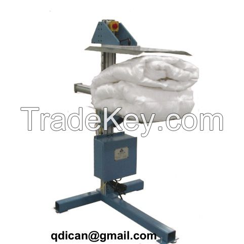 Mattress rolling and packing machine