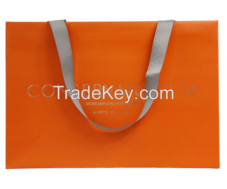 Handmade coloured paper carrier bags with ribbon handles