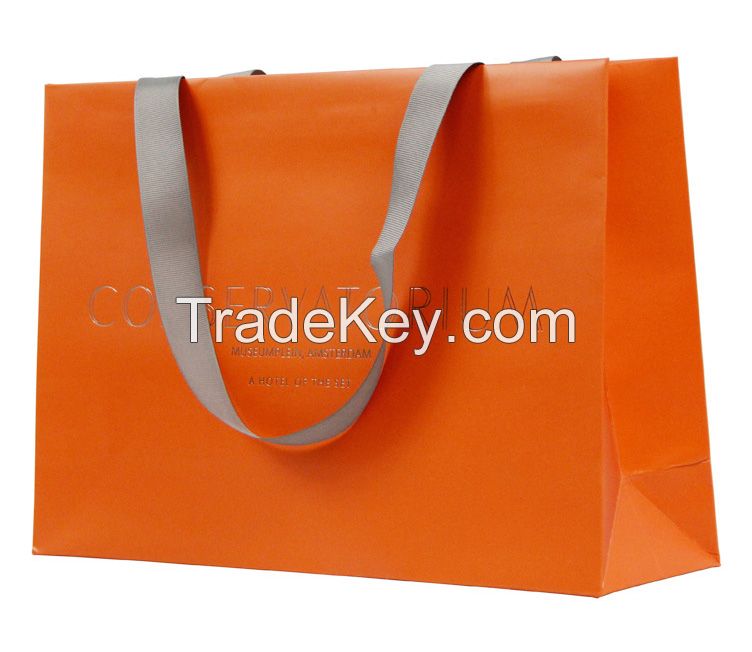 Handmade coloured paper carrier bags with ribbon handles