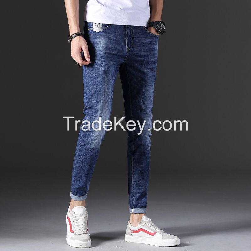 Man&#039;s fashionable dark blue ripped slim fit denim jeans