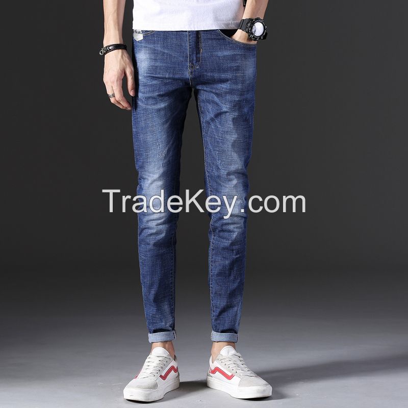 Man's fashionable dark blue ripped slim fit denim jeans