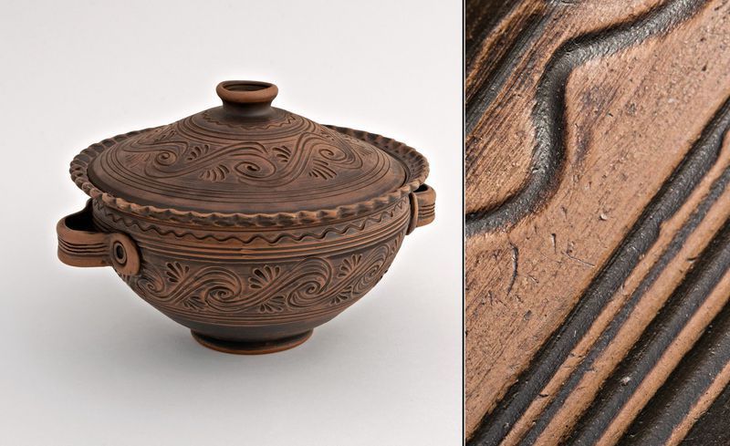 Ceramic bowl with handles and lid made of red clay.
