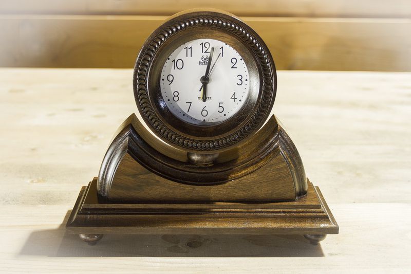 Desk wooden alarm clock with hand carved pattern.