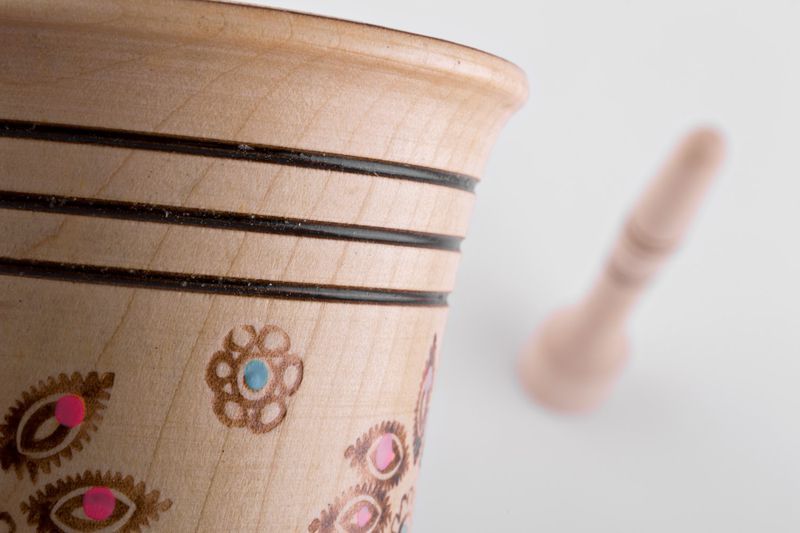 Wooden mortar and pestle for grinding spices by hand.