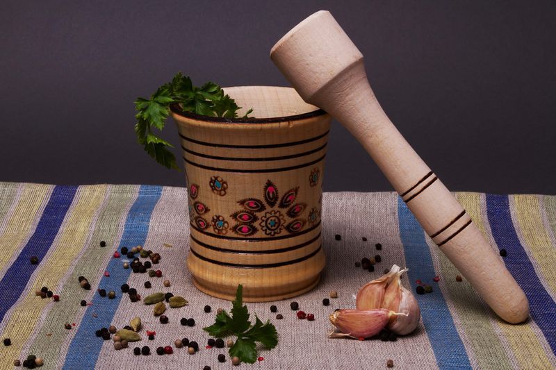 Wooden mortar and pestle for grinding spices by hand.