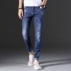 Man's fashionable dark blue ripped slim fit denim jeans