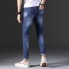 Man's fashionable dark blue ripped slim fit denim jeans