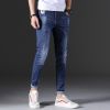 Man's fashionable dark blue ripped slim fit denim jeans