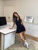 A new V-neck, sleeveless, striped pleated dress