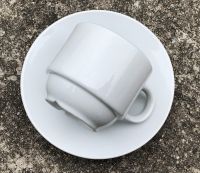 Ceramic white coffee cup and saucer with golden box packing 