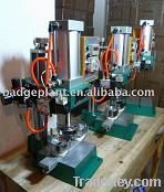 Pneumatic button machine