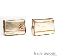 Gold pu cosmetic bag with bronze trim and decorative flower