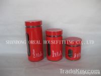 four round glass storage bottles and jars