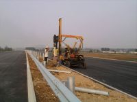 Highway guardrail pile driver